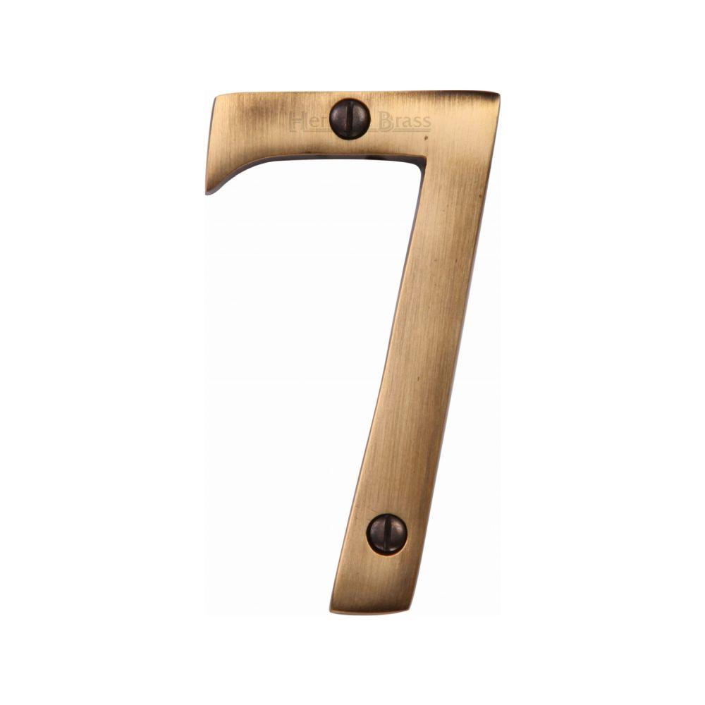 This is an image of a Heritage Brass - Numeral 7 Face Fix 76mm (3") Antique Brass Finish, c1560-7-at that is available to order from T.H Wiggans Ironmongery in Kendal.