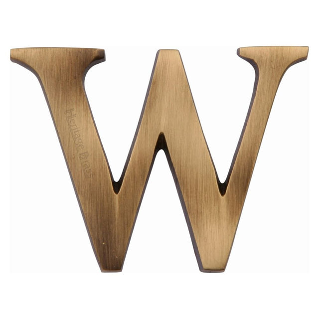 This is an image of a Heritage Brass - Alphabet W Pin Fix 51mm (2") Antique Brass Finish, c1565-2-w-at that is available to order from T.H Wiggans Ironmongery in Kendal.