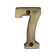 This is an image of a Heritage Brass - Numeral 7 Face Fix 76mm (3") Antique Brass Finish, c1566-7-at that is available to order from T.H Wiggans Ironmongery in Kendal.