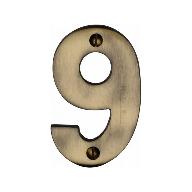 This is an image of a Heritage Brass - Numeral 9 Face Fix 76mm (3") Antique Brass Finish, c1566-9-at that is available to order from T.H Wiggans Ironmongery in Kendal.