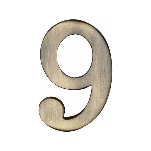 This is an image of a Heritage Brass - Numeral 9 Self Adhesive 51mm (2") Antique Brass Finish, c1568-9-at that is available to order from T.H Wiggans Ironmongery in Kendal.