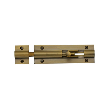 This is an image of a Heritage Brass - Door Bolt Straight 4" x 1.25" Antique Brass Finish, c1582-4-at that is available to order from T.H Wiggans Ironmongery in Kendal.