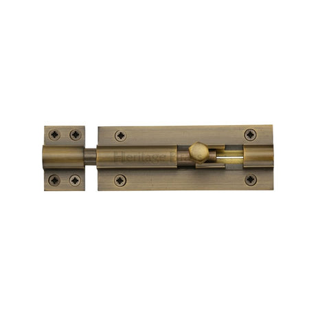 This is an image of a Heritage Brass - Door Bolt Straight 4" x 1.5" Antique Brass Finish, c1584-4-at that is available to order from T.H Wiggans Ironmongery in Kendal.