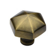 This is an image of a Heritage Brass - Cabinet Knob Classic Hexagon Design 32mm Antique Brass Finish, c2238-at that is available to order from T.H Wiggans Ironmongery in Kendal.
