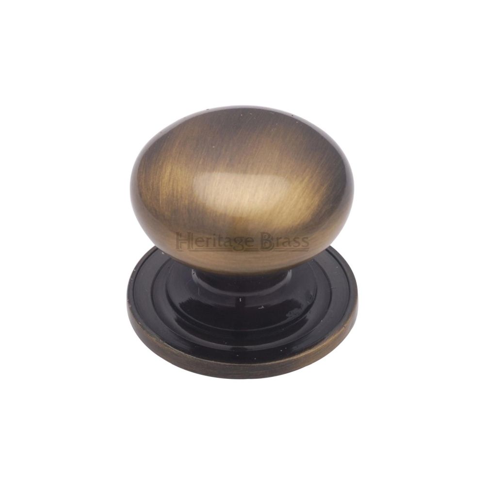 This is an image of a Heritage Brass - Cabinet Knob Victorian Round Design with base 25mm Antique Brass F, c2240-25-at that is available to order from T.H Wiggans Ironmongery in Kendal.