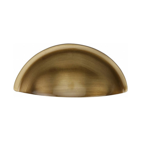 This is an image of a Heritage Brass - Drawer Cup Pull Half Moon Design 57mm CTC Antique Brass Finish, c2760-at that is available to order from T.H Wiggans Ironmongery in Kendal.