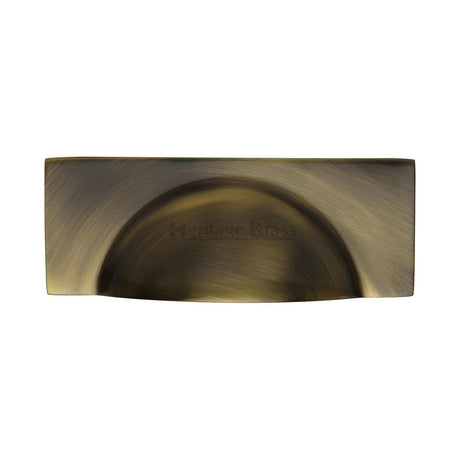 This is an image of a Heritage Brass - Drawer Cup Pull Hampshire Design 57mm CTC Antique Brass Finish, c2764-at that is available to order from T.H Wiggans Ironmongery in Kendal.