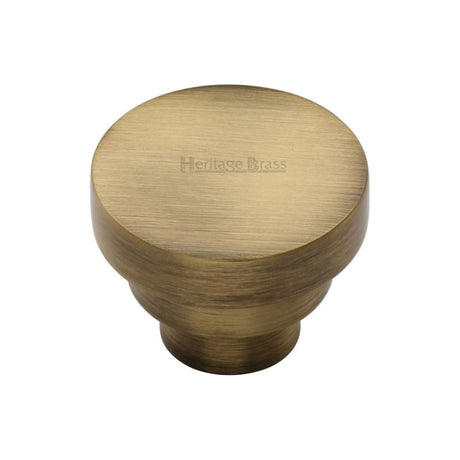 This is an image of a Heritage Brass - Cabinet Knob Round Stepped Design 32mm Antique Brass Finish, c3624-32-at that is available to order from T.H Wiggans Ironmongery in Kendal.