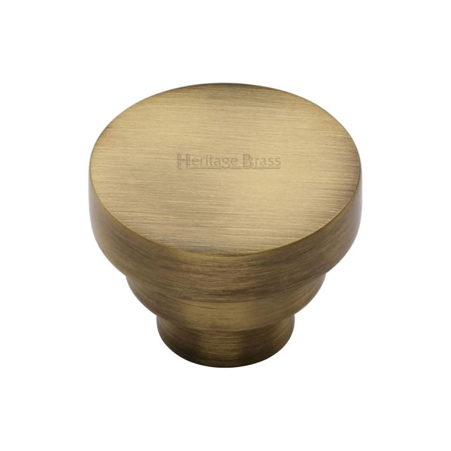 This is an image of a Heritage Brass - Cabinet Knob Round Stepped Design 32mm Antique Brass Finish, c3624-32-at that is available to order from T.H Wiggans Ironmongery in Kendal.