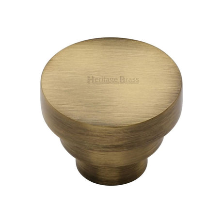 This is an image of a Heritage Brass - Cabinet Knob Round Stepped Design 38mm Antique Brass Finish, c3624-38-at that is available to order from T.H Wiggans Ironmongery in Kendal.