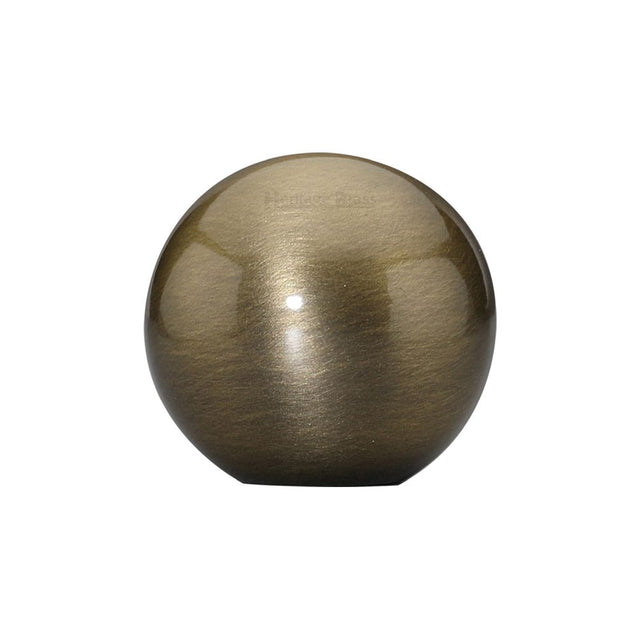 This is an image of a Heritage Brass - Cabinet Knob Globe Design 25mm Antique Brass Finish, c3627-at that is available to order from T.H Wiggans Ironmongery in Kendal.