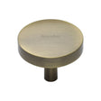 This is an image of a Heritage Brass - Cabinet Knob Domed Disc Design 38mm Antique Brass Finish, c3875-38-at that is available to order from T.H Wiggans Ironmongery in Kendal.