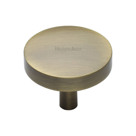 This is an image of a Heritage Brass - Cabinet Knob Domed Disc Design 38mm Antique Brass Finish, c3875-38-at that is available to order from T.H Wiggans Ironmongery in Kendal.