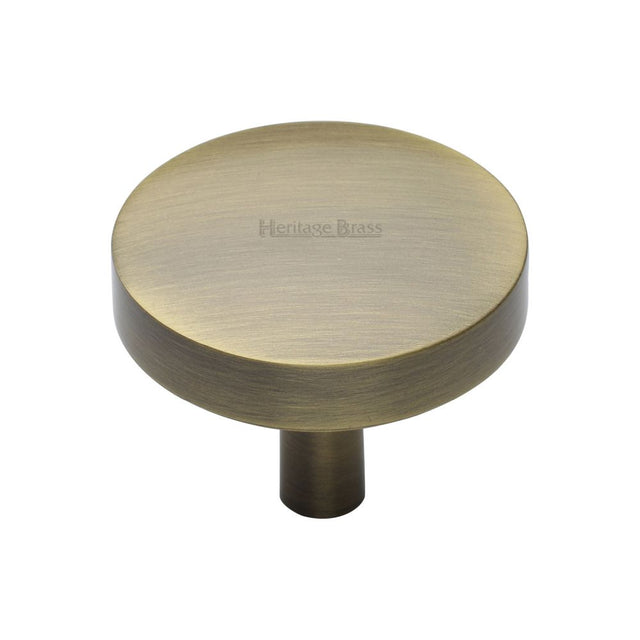This is an image of a Heritage Brass - Cabinet Knob Domed Disc Design 38mm Antique Brass Finish, c3875-38-at that is available to order from T.H Wiggans Ironmongery in Kendal.