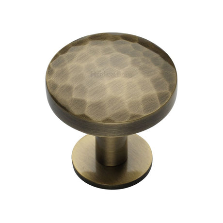 This is an image of a Heritage Brass - Cabinet Knob Round Hammered Design with Rose 32mm Antique Brass Fi, c3876-32-at that is available to order from T.H Wiggans Ironmongery in Kendal.