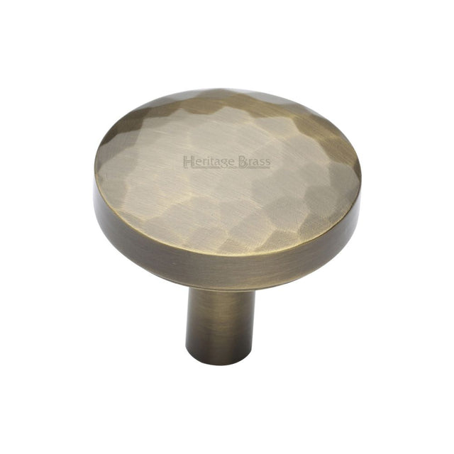 This is an image of a Heritage Brass - Cabinet Knob Round Hammered Design 32mm Antique Brass Finish, c3877-32-at that is available to order from T.H Wiggans Ironmongery in Kendal.