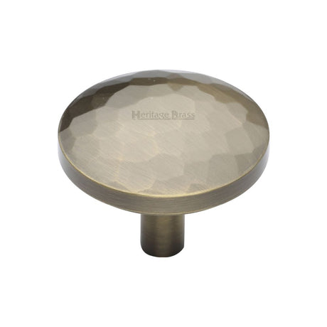 This is an image of a Heritage Brass - Cabinet Knob Round Hammered Design 38mm Antique Brass Finish, c3877-38-at that is available to order from T.H Wiggans Ironmongery in Kendal.