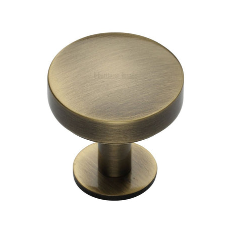 This is an image of a Heritage Brass - Cabinet Knob Domed Disc Design with Rose 32mm Antique Brass Finish, c3878-32-at that is available to order from T.H Wiggans Ironmongery in Kendal.