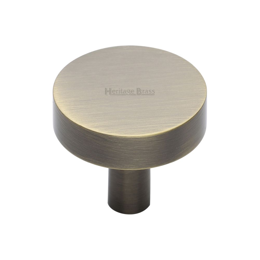 This is an image of a Heritage Brass - Cabinet Knob Disc Design 32mm Antique Brass Finish, c3880-32-at that is available to order from T.H Wiggans Ironmongery in Kendal.