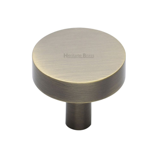 This is an image of a Heritage Brass - Cabinet Knob Disc Design 32mm Antique Brass Finish, c3880-32-at that is available to order from T.H Wiggans Ironmongery in Kendal.