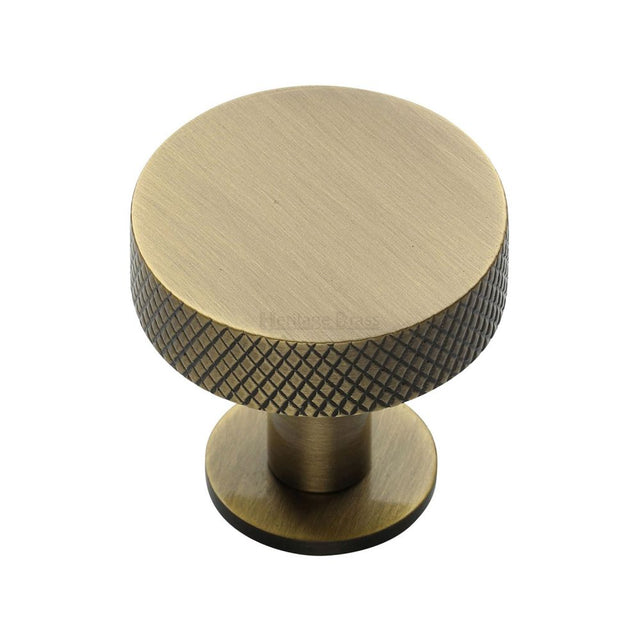 This is an image of a Heritage Brass - Cabinet Knob Disc Knurled Design with Rose 32mm Antique Brass Fini, c3882-32-at that is available to order from T.H Wiggans Ironmongery in Kendal.