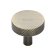 This is an image of a Heritage Brass - Cabinet Knob Knurled Disc Design 32mm Antique Brass Finish, c3884-32-at that is available to order from T.H Wiggans Ironmongery in Kendal.
