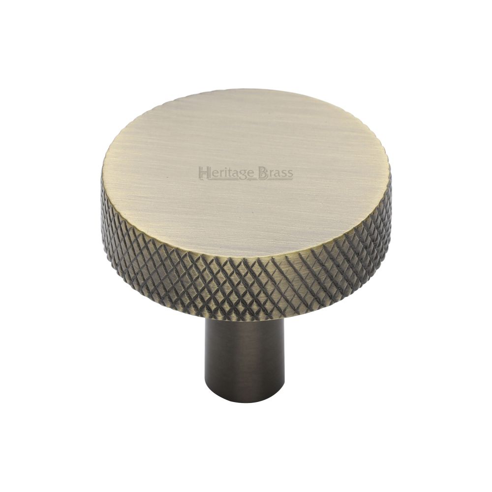 This is an image of a Heritage Brass - Cabinet Knob Knurled Disc Design 32mm Antique Brass Finish, c3884-32-at that is available to order from T.H Wiggans Ironmongery in Kendal.