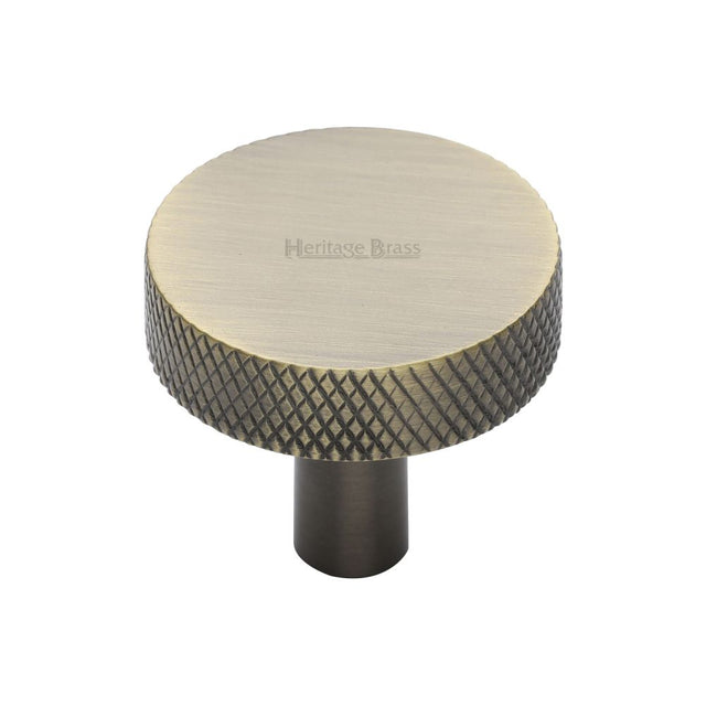This is an image of a Heritage Brass - Cabinet Knob Knurled Disc Design 32mm Antique Brass Finish, c3884-32-at that is available to order from T.H Wiggans Ironmongery in Kendal.