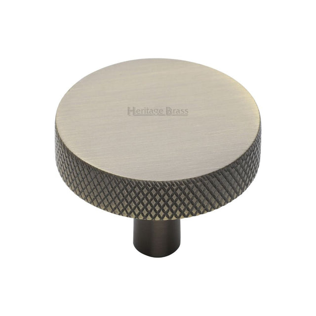 This is an image of a Heritage Brass - Cabinet Knob Knurled Disc Design 38mm Antique Brass Finish, c3884-38-at that is available to order from T.H Wiggans Ironmongery in Kendal.