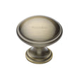 This is an image of a Heritage Brass - Cabinet Knob Domed Design 32mm Antique Brass Finish, c3950-32-at that is available to order from T.H Wiggans Ironmongery in Kendal.