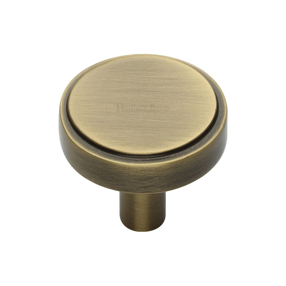 This is an image of a Heritage Brass - Cabinet Knob Stepped Disc Design 32mm Antique Brass Finish, c3952-32-at that is available to order from T.H Wiggans Ironmongery in Kendal.