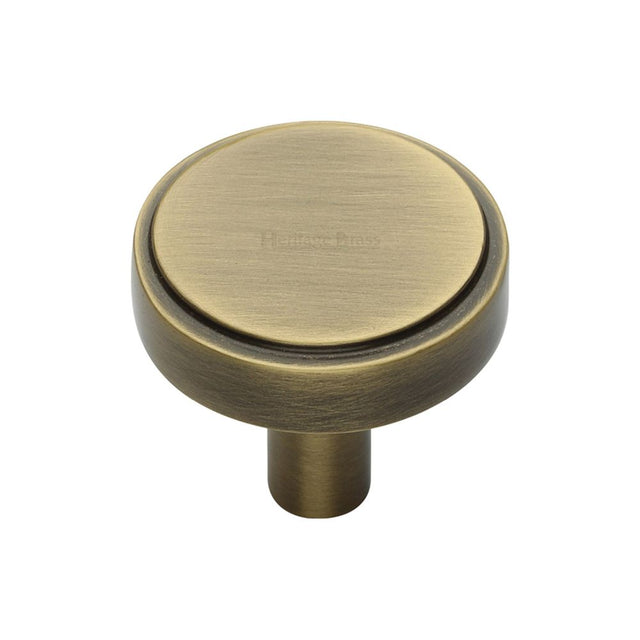This is an image of a Heritage Brass - Cabinet Knob Stepped Disc Design 32mm Antique Brass Finish, c3952-32-at that is available to order from T.H Wiggans Ironmongery in Kendal.