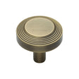 This is an image of a Heritage Brass - Cabinet Knob Ridge Design 32mm Antique Brass Finish, c3956-32-at that is available to order from T.H Wiggans Ironmongery in Kendal.