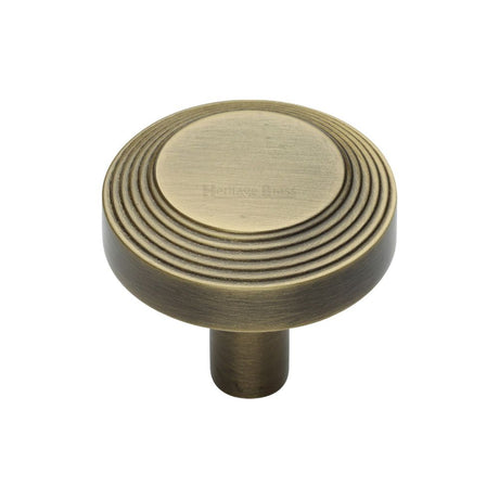 This is an image of a Heritage Brass - Cabinet Knob Ridge Design 32mm Antique Brass Finish, c3956-32-at that is available to order from T.H Wiggans Ironmongery in Kendal.
