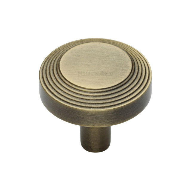 This is an image of a Heritage Brass - Cabinet Knob Ridge Design 32mm Antique Brass Finish, c3956-32-at that is available to order from T.H Wiggans Ironmongery in Kendal.