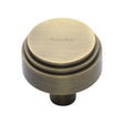 This is an image of a Heritage Brass - Cabinet Knob Round Deco Design 32mm Antique Brass Finish, c3987-32-at that is available to order from T.H Wiggans Ironmongery in Kendal.