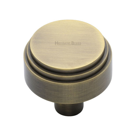 This is an image of a Heritage Brass - Cabinet Knob Round Deco Design 32mm Antique Brass Finish, c3987-32-at that is available to order from T.H Wiggans Ironmongery in Kendal.