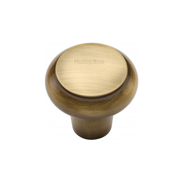 This is an image of a Heritage Brass - Cabinet Knob Round Edge Design 32mm Antique Brass Finish, c3990-32-at that is available to order from T.H Wiggans Ironmongery in Kendal.