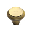 This is an image of a Heritage Brass - Cabinet Knob Round Edge Design 38mm Antique Brass Finish, c3990-38-at that is available to order from T.H Wiggans Ironmongery in Kendal.