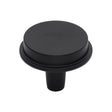This is an image of a Heritage Brass - Flat Round Knob Design 38 mm Matt Black finish, c4592-38-bkmt that is available to order from T.H Wiggans Ironmongery in Kendal.