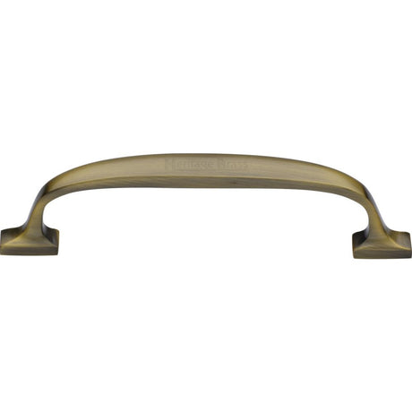 This is an image of a Heritage Brass - Cabinet Pull Durham Design 128mm CTC Antique Brass Finish, c7213-128-at that is available to order from T.H Wiggans Ironmongery in Kendal.