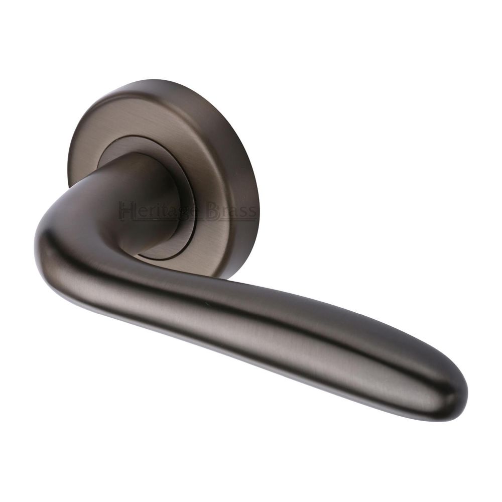 This is an image of a Heritage Brass - Door Handle Lever Latch on Round Rose Columbus Design Matt Bron, col1762-mb that is available to order from T.H Wiggans Ironmongery in Kendal.