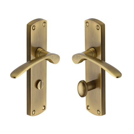 This is an image of a Heritage Brass - Door Handle for Bathroom Diplomat Design Antique Brass Finish, dip7830-at that is available to order from T.H Wiggans Ironmongery in Kendal.