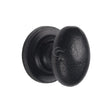This is an image of a M.Marcus - Black Iron Rustic Cabinet Knob on Round Plate Oval Design 32mm, fb179-32 that is available to order from T.H Wiggans Ironmongery in Kendal.