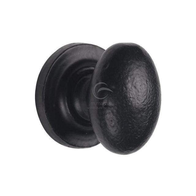 This is an image of a M.Marcus - Black Iron Rustic Cabinet Knob on Round Plate Oval Design 38mm, fb179-38 that is available to order from T.H Wiggans Ironmongery in Kendal.