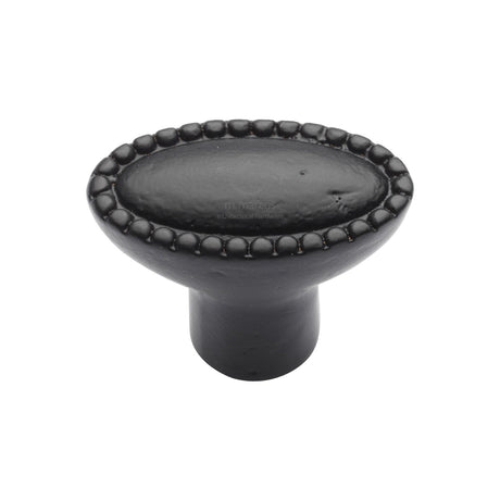 This is an image of a M.Marcus - Matt Black Rustic Iron Cabinet Knob Opal Design 38mm, fb3621 that is available to order from T.H Wiggans Ironmongery in Kendal.