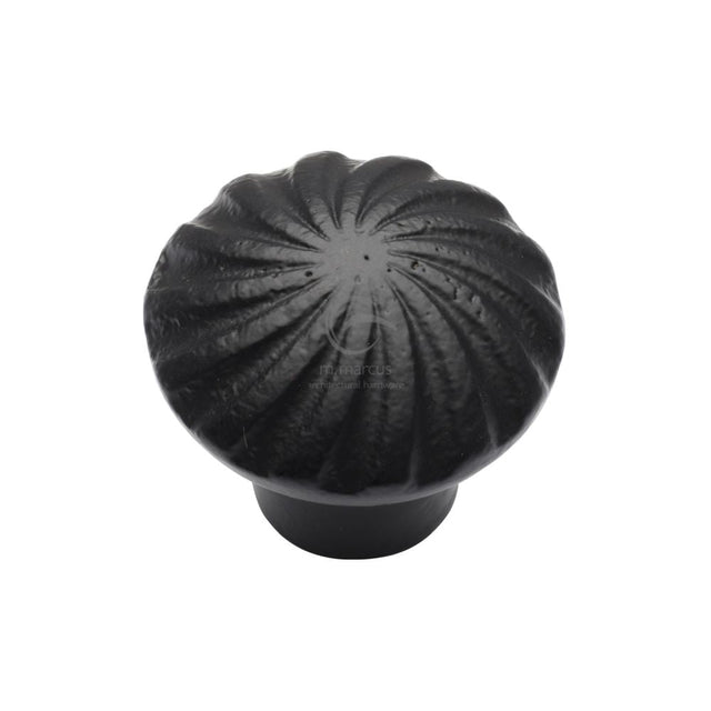 This is an image of a M.Marcus - Black Iron Rustic Cabinet Knob Wheel Design 32mm, fb3891-32 that is available to order from T.H Wiggans Ironmongery in Kendal.