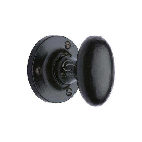 This is an image of a M.Marcus - Black Iron Rustic Mortice Knob on Rose Knowle Design, fb4555 that is available to order from T.H Wiggans Ironmongery in Kendal.