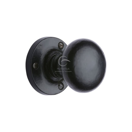 This is an image of a M.Marcus - Black Iron Rustic Mortice Knob on Rose Alveley Design, fb4975 that is available to order from T.H Wiggans Ironmongery in Kendal.