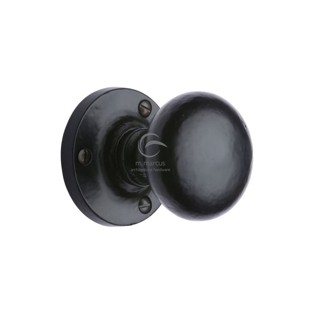 This is an image of a M.Marcus - Black Iron Rustic Mortice Knob on Rose Alveley Design, fb4975 that is available to order from T.H Wiggans Ironmongery in Kendal.